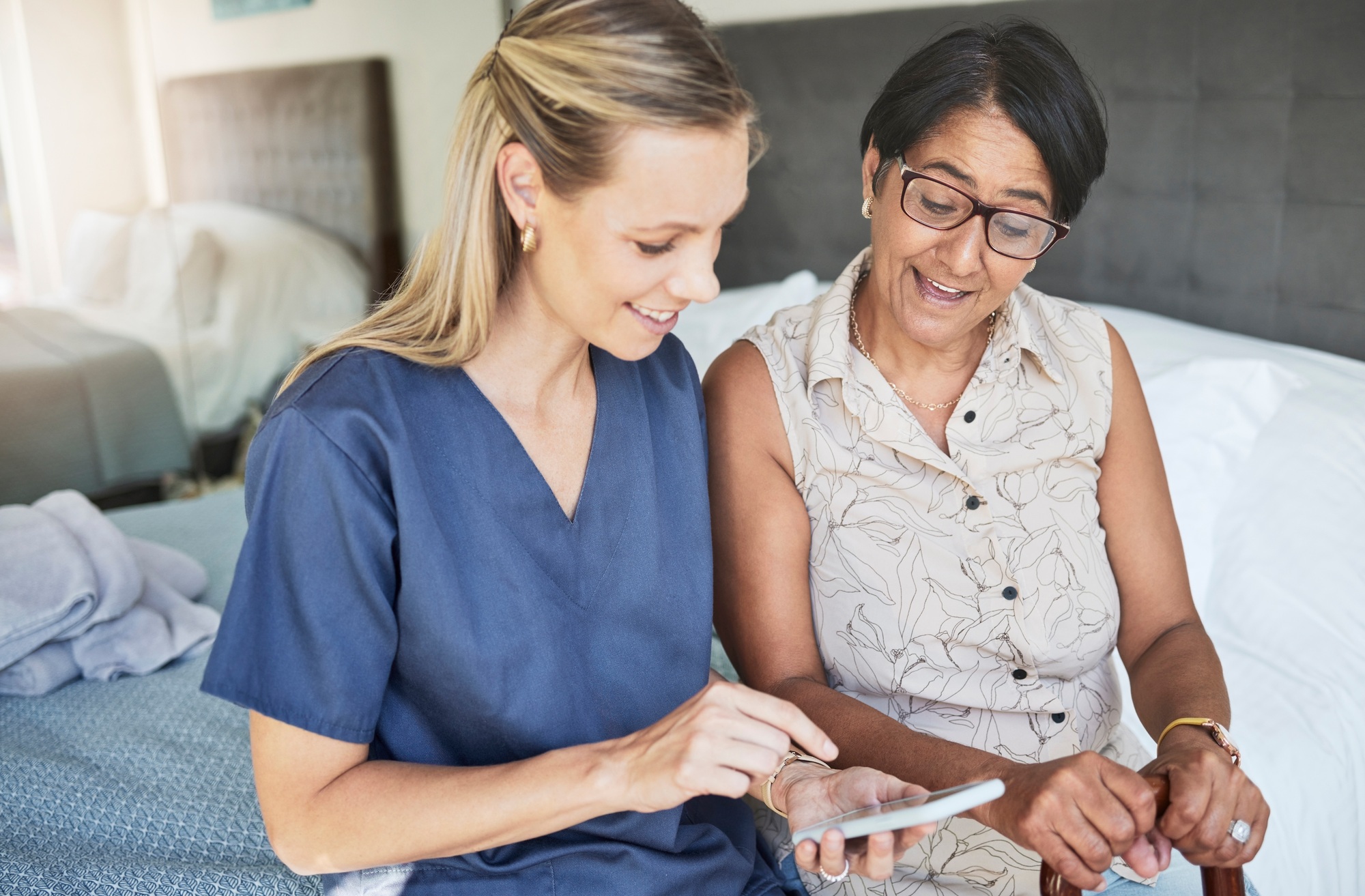 Happy woman, nurse and phone in elderly care for consultation, support or healthcare diagnosis at h